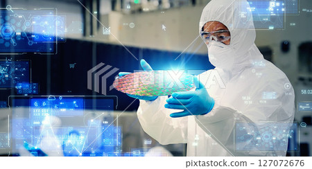 Digital technology concept with worker inspecting silicon wafer in semiconductor factory 127072676