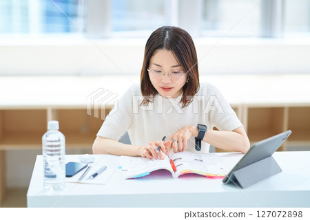 woman studying by text woman studying by text 127072898