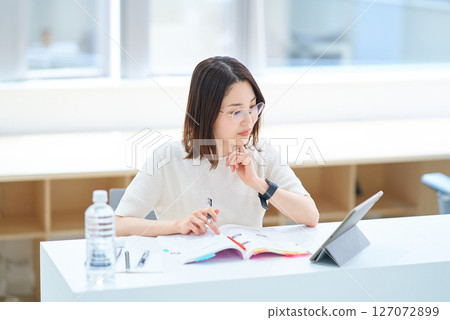 woman studying by text woman studying by text 127072899
