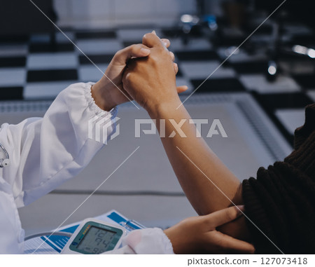 Orthopaedic doctor doing physical examination patient with wrist pain at the clinic. Physical therapist checks the patient wrist by pressing the wrist bone. Orthopaedic doctor doing physical examination patient with wrist pain at the clinic. Physical therapist checks the patient wrist by pressing the wrist bone. 127073418