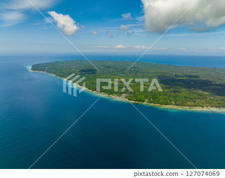 Tropical Island surrounded by beach and blue sea. Blue sky and clouds. Samal, Davao. Philippines. Tropical Island surrounded by beach and blue sea. Blue sky and clouds. Samal, Davao. Philippines. 127074069