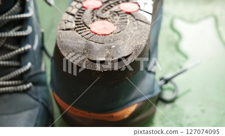 Worn-down soles with holes in them, worn heels, winter shoes Worn-down soles with holes in them, worn heels, winter shoes 127074095