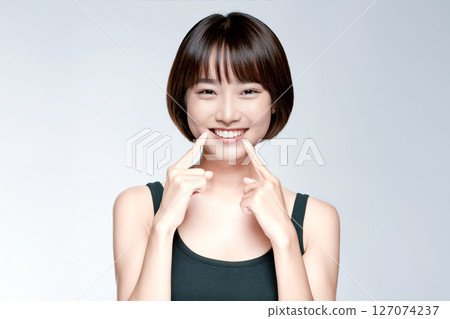 A young Japanese woman becomes more beautiful after getting her teeth straightened A young Japanese woman becomes more beautiful after getting her teeth straightened 127074237