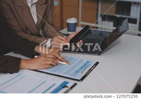 Accounting company provide finance and taxation planning for profitable cash flow, Auditor and accountant team working in office, analyze financial data and accounting record with calculator.Insight 127075250