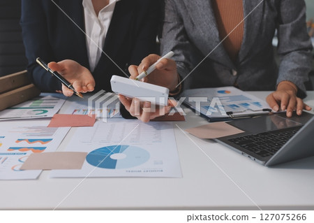 Accounting company provide finance and taxation planning for profitable cash flow, Auditor and accountant team working in office, analyze financial data and accounting record with calculator.Insight 127075266