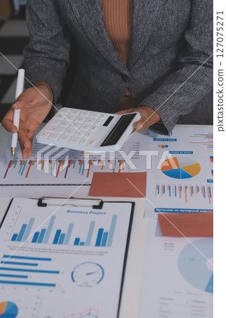Accounting company provide finance and taxation planning for profitable cash flow, Auditor and accountant team working in office, analyze financial data and accounting record with calculator.Insight Accounting company provide finance and taxation planning for profitable cash flow, Auditor and accountant team working in office, analyze financial data and accounting record with calculator.Insight 127075271