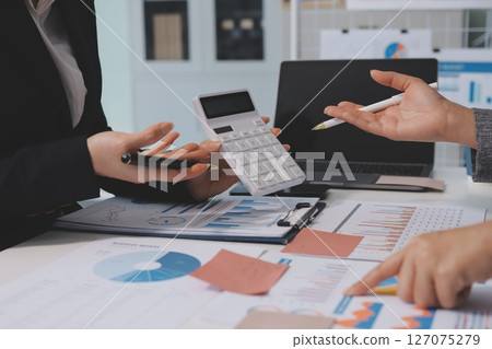 Accounting company provide finance and taxation planning for profitable cash flow, Auditor and accountant team working in office, analyze financial data and accounting record with calculator.Insight 127075279