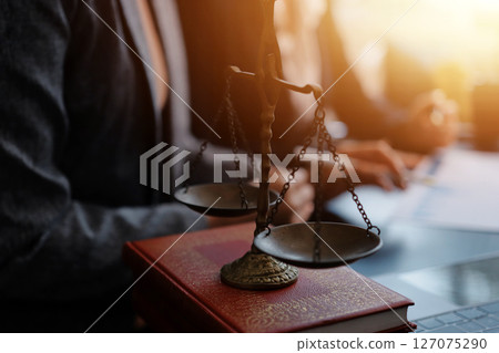 Judge gavel with Justice lawyers having team meeting at law firm background. Concepts of Law and Legal services. Judge gavel with Justice lawyers having team meeting at law firm background. Concepts of Law and Legal services. 127075290
