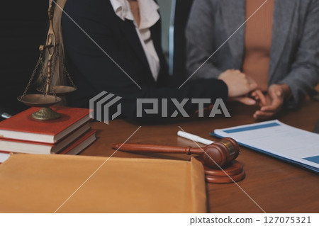 Judge gavel with Justice lawyers having team meeting at law firm background. Concepts of Law and Legal services. 127075321