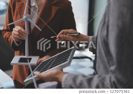 Discussion among businesspeople on the latest developments in solar cell panel technology and Solar Energy Environment city Concept. Discussion among businesspeople on the latest developments in solar cell panel technology and Solar Energy Environment city Concept. 127075361