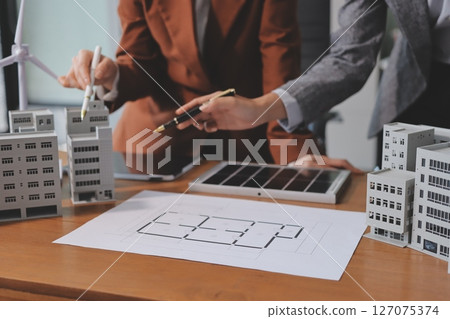 Discussion among businesspeople on the latest developments in solar cell panel technology and Solar Energy Environment city Concept. Discussion among businesspeople on the latest developments in solar cell panel technology and Solar Energy Environment city Concept. 127075374