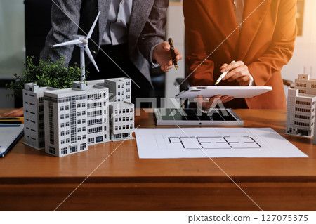 Discussion among businesspeople on the latest developments in solar cell panel technology and Solar Energy Environment city Concept. Discussion among businesspeople on the latest developments in solar cell panel technology and Solar Energy Environment city Concept. 127075375