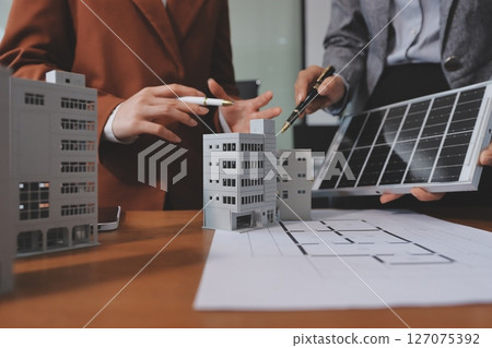 Discussion among businesspeople on the latest developments in solar cell panel technology and Solar Energy Environment city Concept. Discussion among businesspeople on the latest developments in solar cell panel technology and Solar Energy Environment city Concept. 127075392