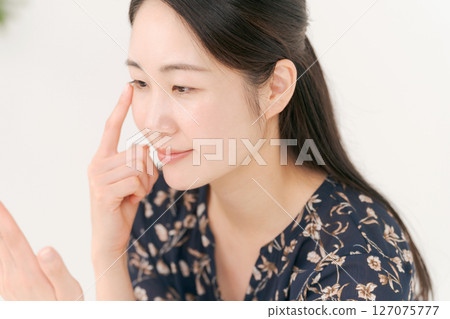 Woman touching her eyes Woman touching her eyes 127075777