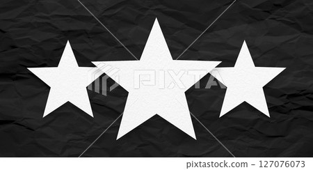 White paper stars, isolated on black crumpled paper background. 127076073