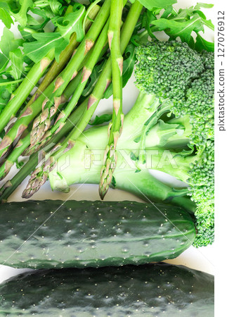Still life from green farm vegetables, arugula, broccoli, asparagus and cucumbers on white background 127076912