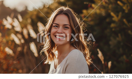 Portrait of a beautiful young woman smiling and looking at camera. Woman portrait Portrait of a beautiful young woman smiling and looking at camera. Woman portrait 127076925
