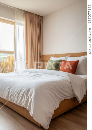Cozy bedroom interior with natural light and minimalist decor in a modern apartment 127077121