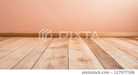 Warm wooden floor with a simple pink wall in a well-lit interior space 127077306