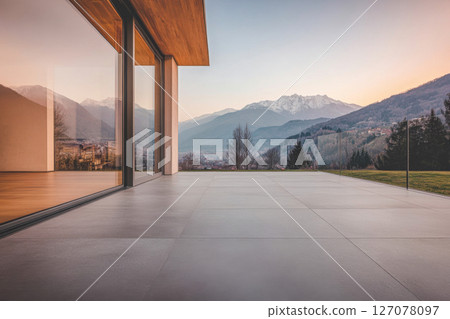 Modern terrace with breathtaking mountain view at sunset in a serene countryside setting 127078097