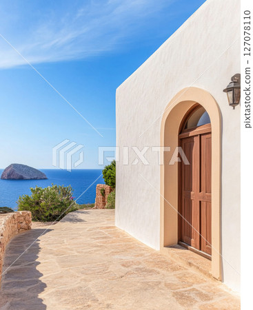 Coastal pathway leading to a serene entrance near the ocean on a sunny day in a tranquil location 127078110