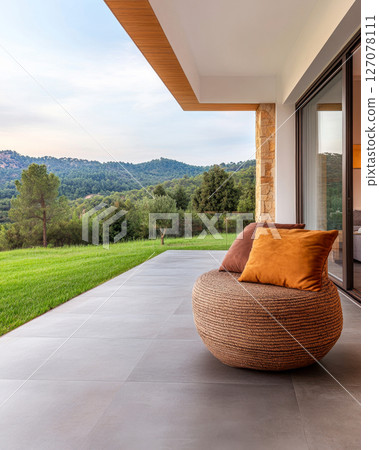 Cozy outdoor seating area with panoramic mountain views at sunset in a tranquil setting 127078111