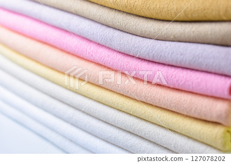 stack of colourful cotton clothes, close up pile of clothing stack of colourful cotton clothes, close up pile of clothing 127078202