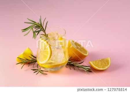 Summer refreshing drink with ice, lemon and rosemary. Summer refreshing drink with ice, lemon and rosemary. 127078814