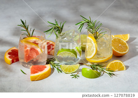 Summer refreshing drinks with ice, citrus and rosemary. 127078819