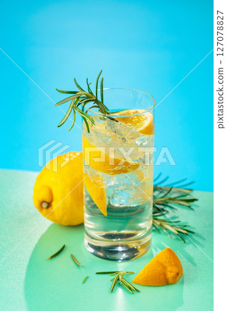 Refreshing cocktail with gin, tonic, lemon, and rosemary. 127078827
