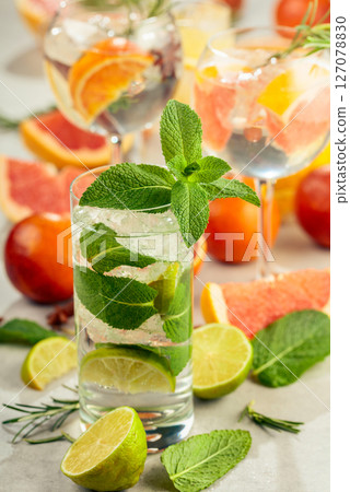 Refreshing summer cocktails with citrus on a white marble table. Refreshing summer cocktails with citrus on a white marble table. 127078830
