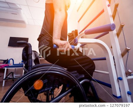 Disabled man training in the gym. Rehabilitation center Disabled man training in the gym. Rehabilitation center 127079197