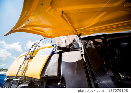 Modern agricultural machinery and equipment. Yellow agricultural harvester. Modern agricultural machinery and equipment. Yellow agricultural harvester. 127079198