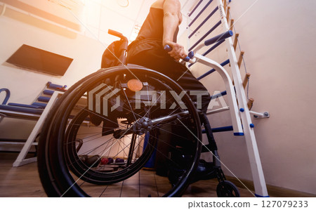 Disabled man training in the gym. Rehabilitation center 127079233
