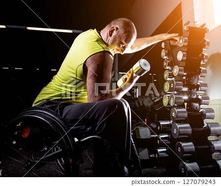 Disabled man training in the gym of rehabilitation center 127079243