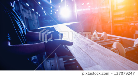 Carpenter with fibreboards at furniture factory workshop. Woodworking industry 127079247