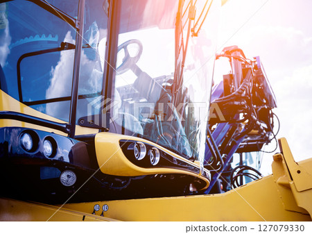 Modern agricultural machinery and equipment. Yellow agricultural harvester. 127079330