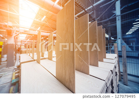 Production line of the wooden floor factory. CNC automatic woodworking machine. 127079495