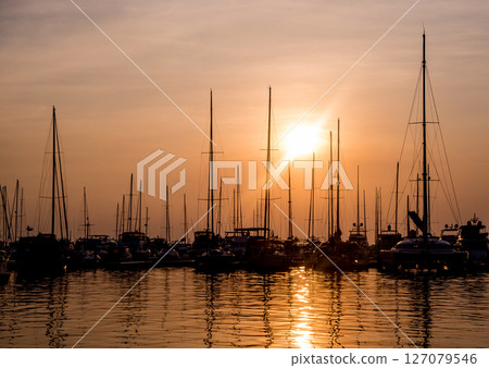 Beautiful view of marina and harbor with yachts and motorboats. Beautiful view of marina and harbor with yachts and motorboats. 127079546
