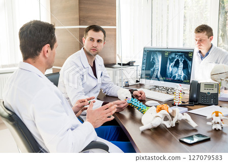 Doctors team having medical council in hospital. Discussing medical issues.  127079583