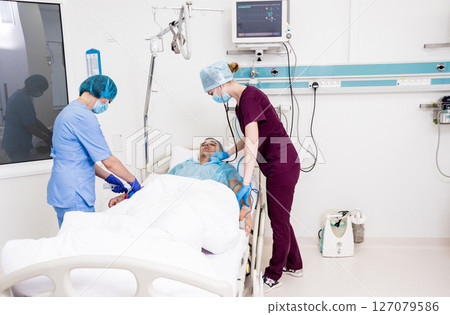 Doctors give resuscitation to a male patient in the emergency room. Doctors give resuscitation to a male patient in the emergency room. 127079586