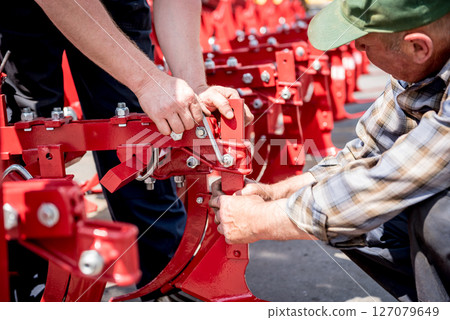 The mechanics repair combine harvester. Modern agricultural machinery 127079649