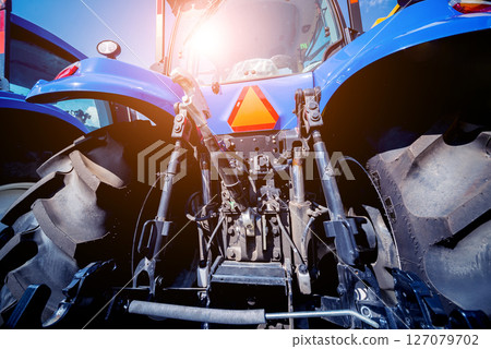 Rear view of modern agricultural tractor. Industrial details. Rear view of modern agricultural tractor. Industrial details. 127079702