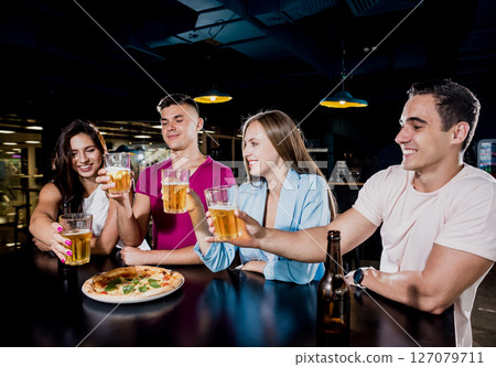 Cheerful friends in the pub. Drinking beer, wine and whisky Cheerful friends in the pub. Drinking beer, wine and whisky 127079711