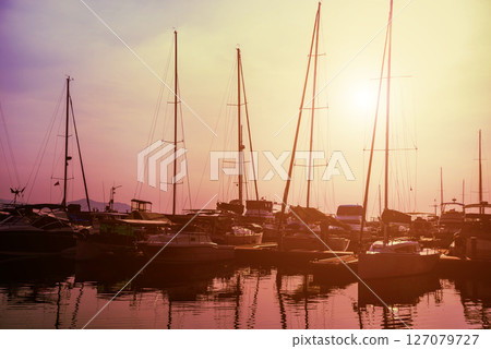 Beautiful view of marina and harbor with yachts and motorboats. Beautiful view of marina and harbor with yachts and motorboats. 127079727