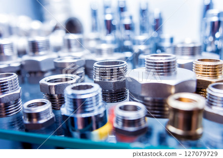 Hosepipe fittings on the table. Plumbing pipeline spare parts. 127079729