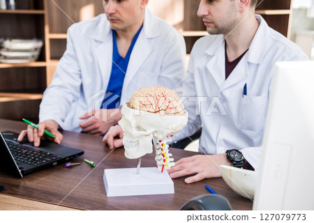 Two doctors having medical council in hospital. Two doctors having medical council in hospital. 127079773