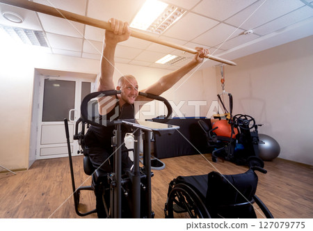 Disabled man training in the gym. Rehabilitation center 127079775