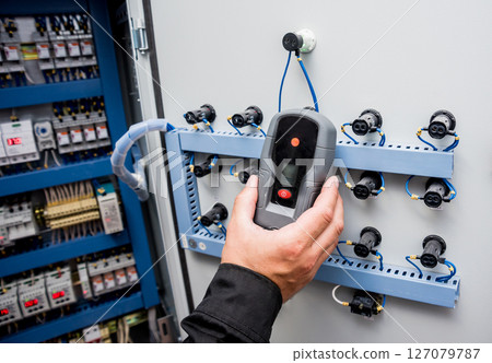 Electrical measurements with multimeter tester. Modern electrical background. 127079787