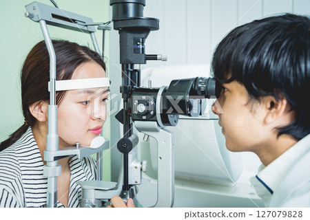 Consultation with an ophthalmologist. Young asian woman and doctor  Consultation with an ophthalmologist. Young asian woman and doctor  127079828